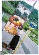 A woman standing in front of a large billboard.