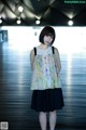 A woman standing in an airport with her hands on her hips.