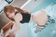 A woman in a black and white bathing suit in a pool.