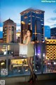 A woman in a green dress standing on a balcony.